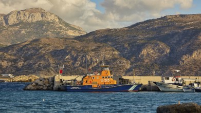 Harbour with fishing boats in front of a mountainous coast, Pigadia, town and harbour, coast guard