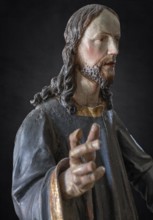 Christ on the palm donkey, detail, wooden figure from around 1880, on a dark background, Dominican