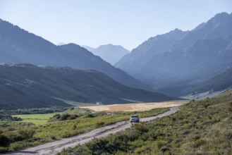 Car on gravel road, Tien Shan Mountains, Kyrgyzstan, Asia