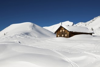 Snow-covered mountains and mountain hut with ski slope, Damüls, Bregenzerwald, Vorarlberg, Austria,