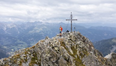 Aerial view, hiker on the Raudenspitze with summit cross, Carnic High Trail, Carnic Main Ridge,