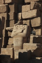 Luxor, Karnak Temple, headless statue with the symbol of the key to life, the Ankh, in the temple