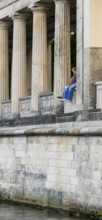 Young couple among the columns of the Neues Museum, Berlin, Germany, Europe