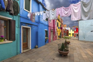 Colourful houses with laundry on the line in between, Burano, Venice, Veneto, Italy, Europe