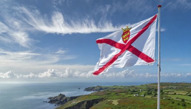 The flag of the Isle of Jersey, Great Britain flutters in the wind