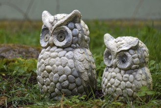 Two eagle owl figures in the garden, Bavaria, Germany, Europe