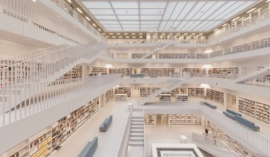 Modern, bright library with open staircases and many bookshelves in a symmetrical arrangement,