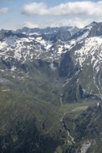 View of mountain peak with snow and mountain hut Berliner Hütte with Zemmbach in the valley