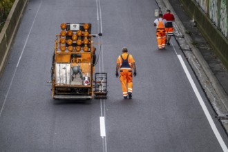 Marking work after the application of new whisper asphalt surface for the A40 motorway, in the