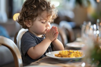 Young boy child praying at kitchen table before dinner. Generative Ai, AI generated