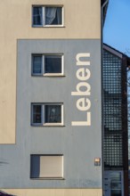 Residential buildings, rented flat, façade with the inscription Leben, on Adolf-Schmidt-Strasse,