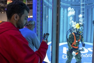 Federal Navy mine divers present themselves in the diving tank in the diving hall at BOOT 2024, the