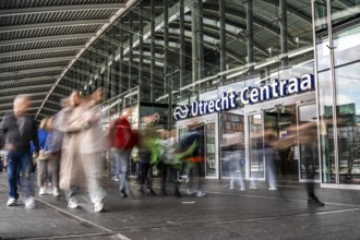 Station forecourt of Utrecht Centraal station, people on their way to, from the station,