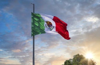 Los Cabos, Mexico, Mexican tricolor national striped flag proudly waving at mast in the air with