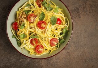 Yellow zucchini salad, with cherry, vegetarian food, sliced into strips, homemade