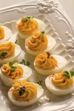 Boiled eggs stuffed with yolk with mayonnaise, on a white plate, selective focus, blurry, close-up,