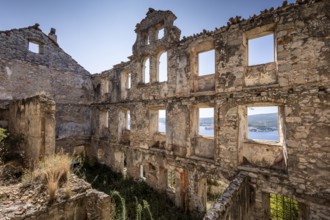 View through the windows of a dilapidated building to the blue sky and the sea, Peljesac, Croatia,