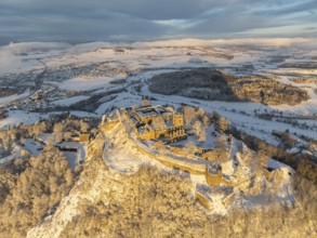 Aerial view of the snow-covered Hegau volcano Hohentwiel with Germany's largest castle ruins on a