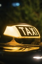 Close-up of an illuminated taxi roof sign at night, Stuttgart, Germany, Europe