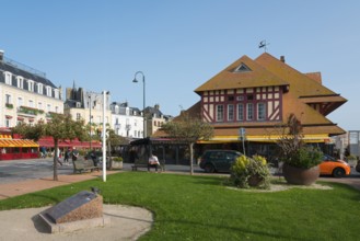 Half-timbered building with green lawn in an urban setting in sunny weather, fish market,