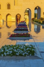 Marble-framed flowerbeds in front of the Royal Opera House in the evening light, Muscat, Arabian