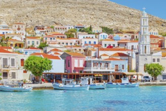 View of Emporio harbour and Saint Nicholas church in the distance, Halki Island, Dodecanese