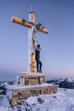 Summit bliss in the snow-covered winter landscape in the Tannheimer Tal in the Alps on the