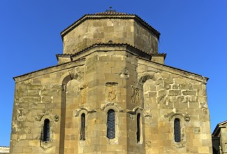 East façade of the Dzhvari Cross Church with three architectural bas-reliefs depicting the church