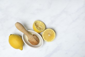 Lemons and lemon squeezer, squeezed lemon and lemon juice