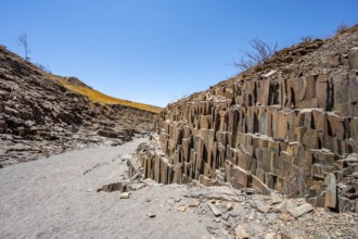 Dry river valley with basalt rocks, rock formation Organ Pipes, Damaraland, Kunene, Namibia, Africa