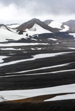 Dramatic volcanic landscape with mountains and snow, at Höskuldsskáli hut in Hrafntinnusker,