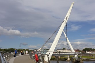 Side view of a modern bridge under a clear blue sky, Londonderry