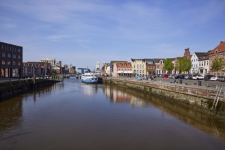 Husum harbour with harbour basin, surrounding restaurants and houses in Husum, Nordfriesland