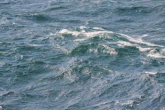 Dynamic sea waves with foaming water in different shades of blue, North Sea, Denmark, Europe