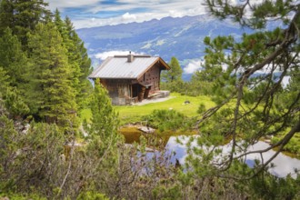 Secluded hut in the mountains, surrounded by forest and meadow, peaceful atmosphere, Penken,