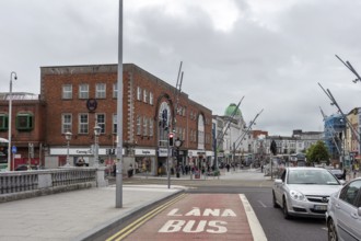 Street view in a city centre with traffic and modern architecture, Cork