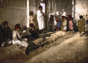 Beggar in front of the mosque Sidi Abderrhaman, Algiers, Algeria, ca 1890, Historical, digitally