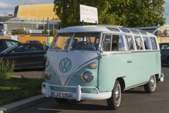 Mint green VW vintage bus on a street in Berlin, retro style, city tour with VW Bulli, VW T1,