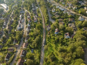 Rails and roads between densely overgrown residential areas, track construction, rail delivery for