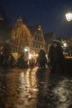 Lively old town with festively illuminated houses and people at night, Christmas market Calw, Black