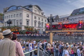 Spectators on grandstand at the Graslei watching Pole Pole podium during Gentse Feesten, Ghent city