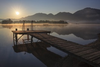 Footbridge on lake in front of mountains, sunrise, summer, silence, Lake Kochel, Alpine foothills,