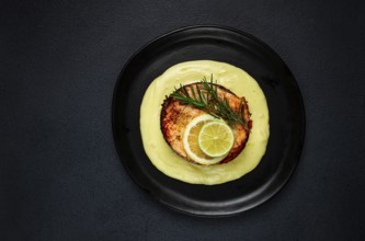 Salmon steak, fried, mashed potatoes, top view, rosemary, lemon and lime, homemade, one serving, no