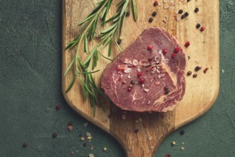 Fresh, raw rib eye steak, on a chopping board, top view, no people