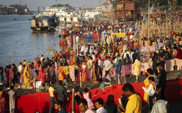 Hindu devotees crowd to perform rituals to the Sun god in the bank of Brahmaputra river on the