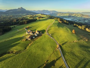 Mountain range near village Wertach, view to mt. Gruenten, sunrise, fog in valley, traditional