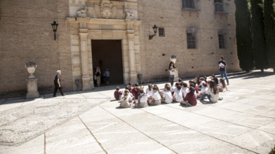 School children listen to their teacher on an educational visit to the historic sites of Granada,