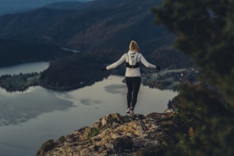 Trail running in autumn on the Jochberg on Lake Walchensee against the wonderful backdrop of the