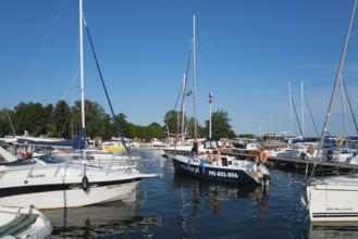 Several sailing boats in the harbour under a clear blue sky on a summer day, Gizycko,