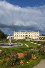 Colourful flower garden in front of a baroque castle with dramatic sky, Branicki Palace, Castle,